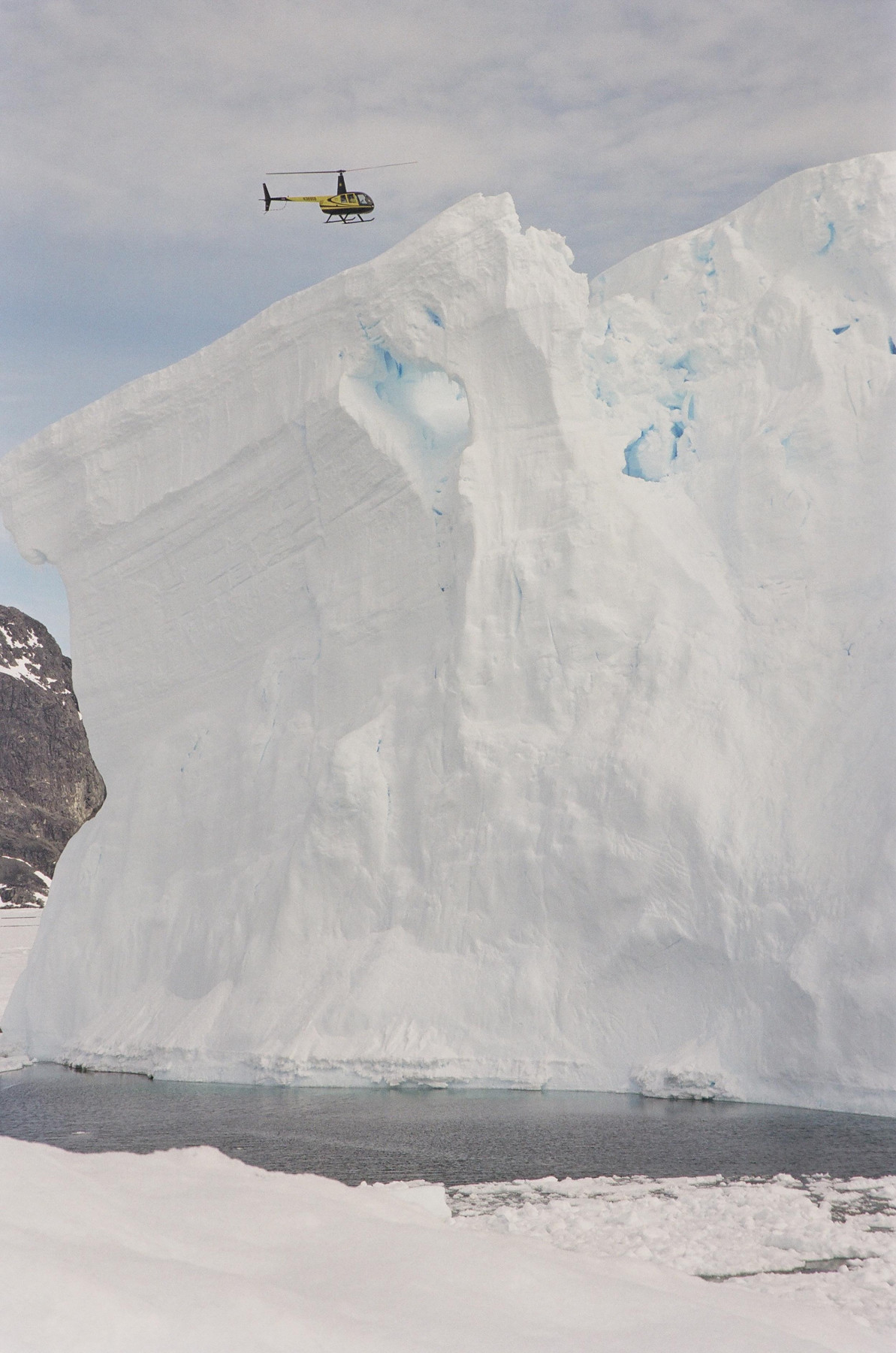 Helicopter over iceberg