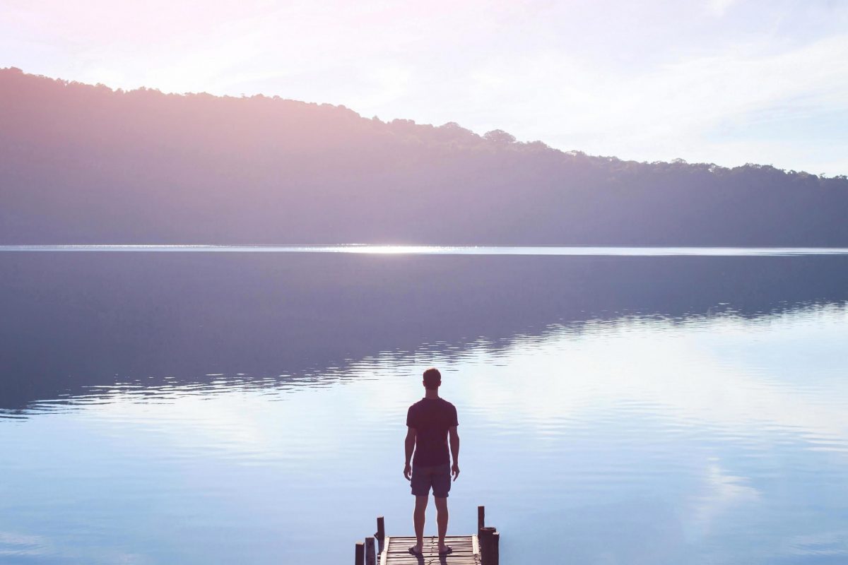 Man standing in front of lake