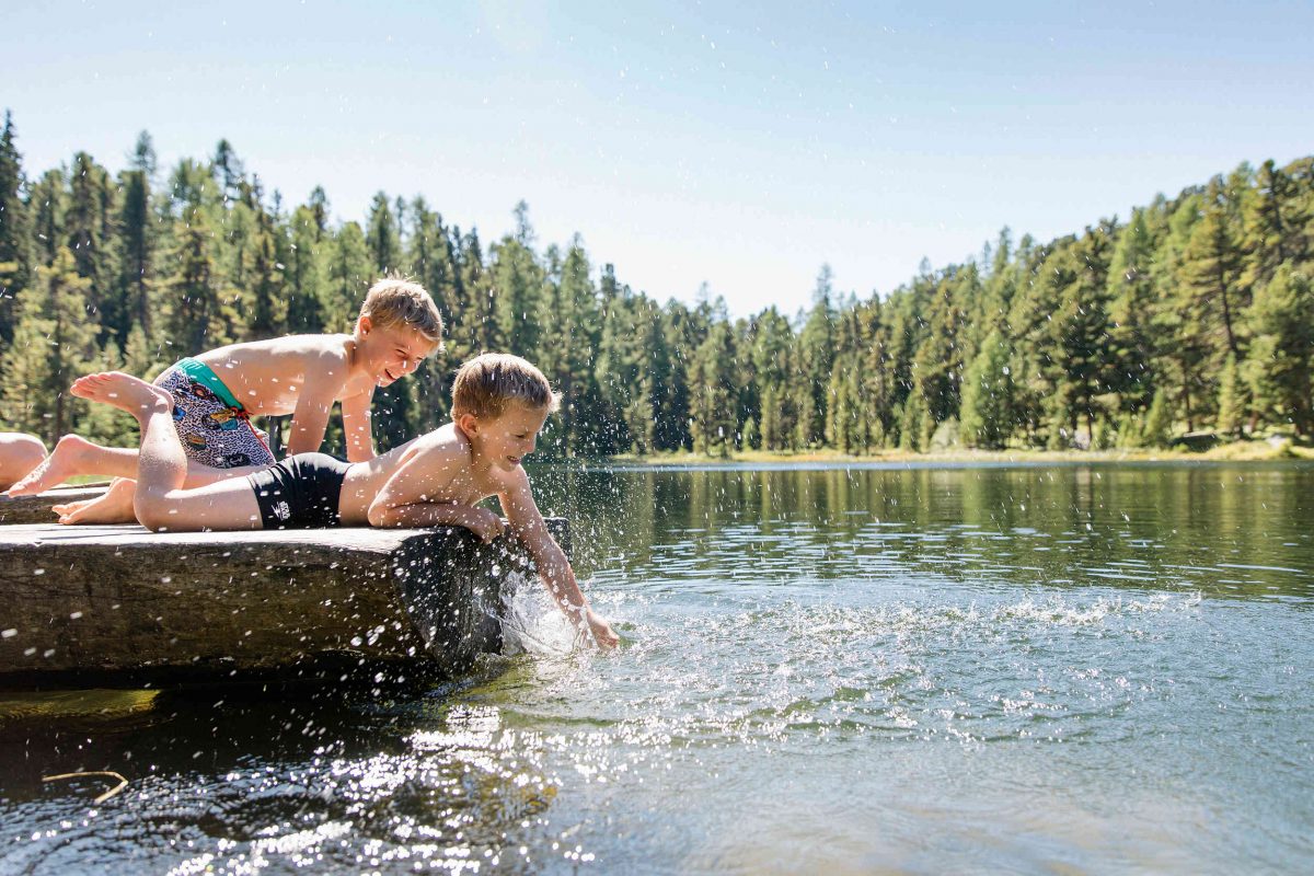 Children enjoy relaxing by the lakes in the Engadin