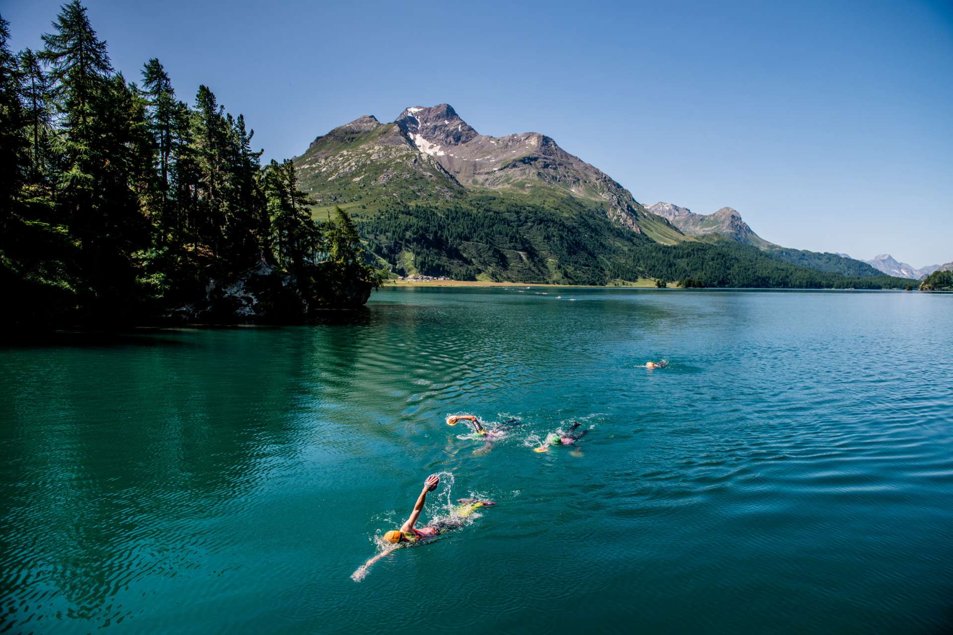 People wild swimming in a lake in the Engadin