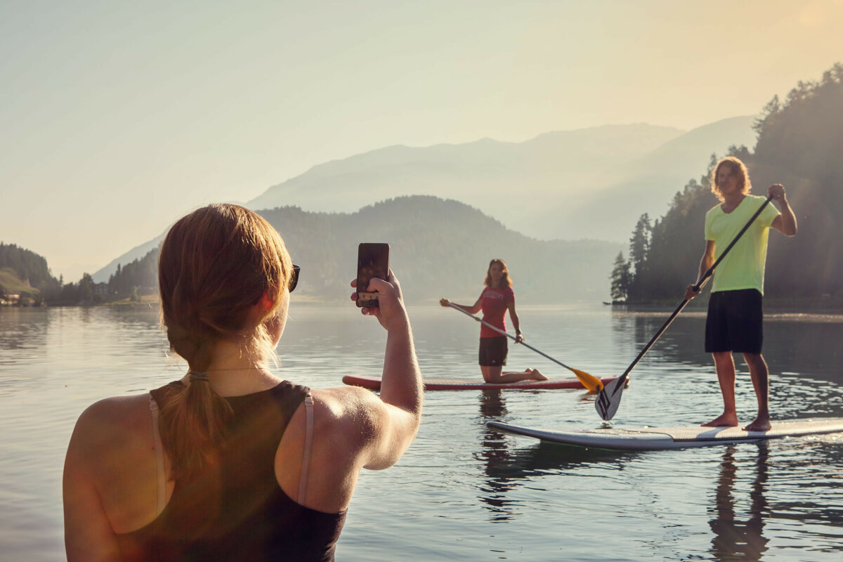 Taking photos of paddleboarders on a mountain lake