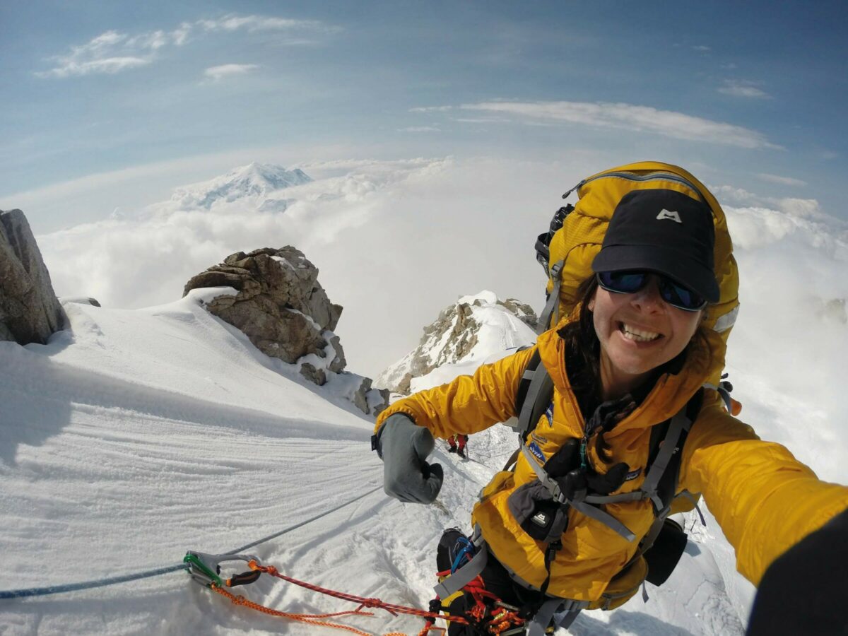 A woman climbing a mountain