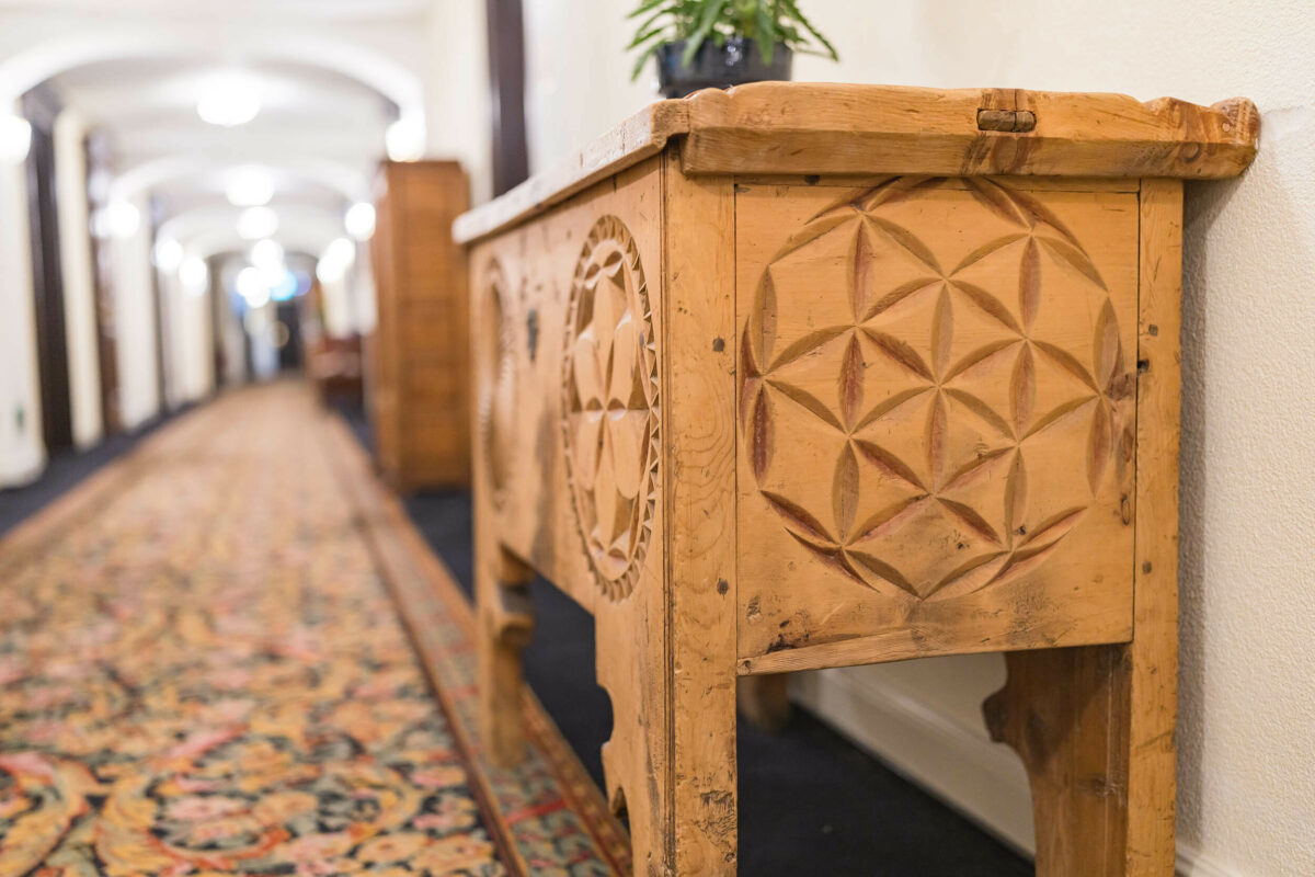 Carved wooden antique trunk in a hotel corridor