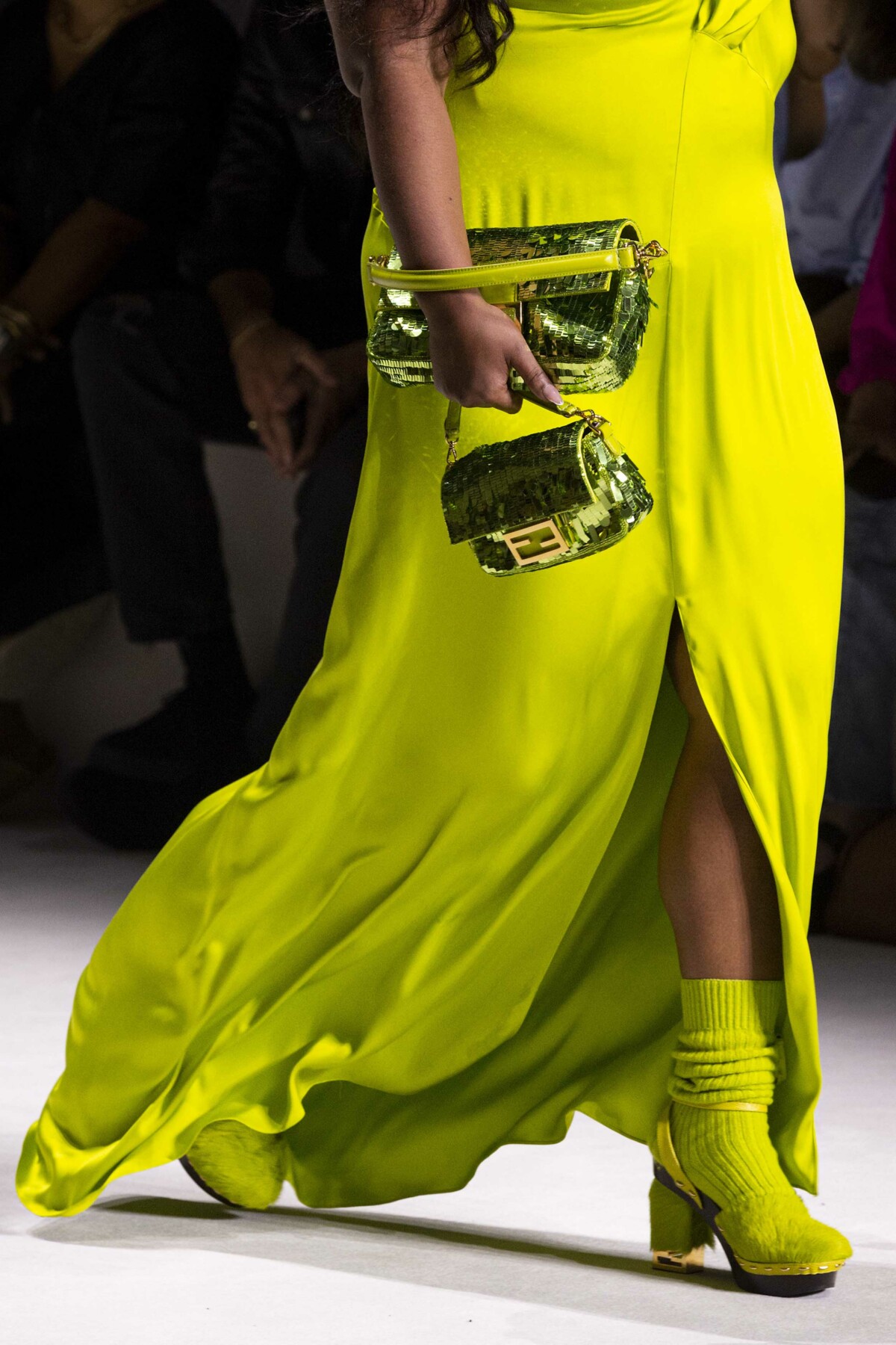 Green sequinned bag carried by a model on the catwalk