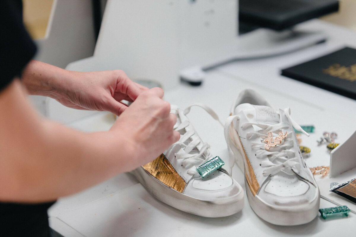 Someone personalising a pair of luxury sneakers