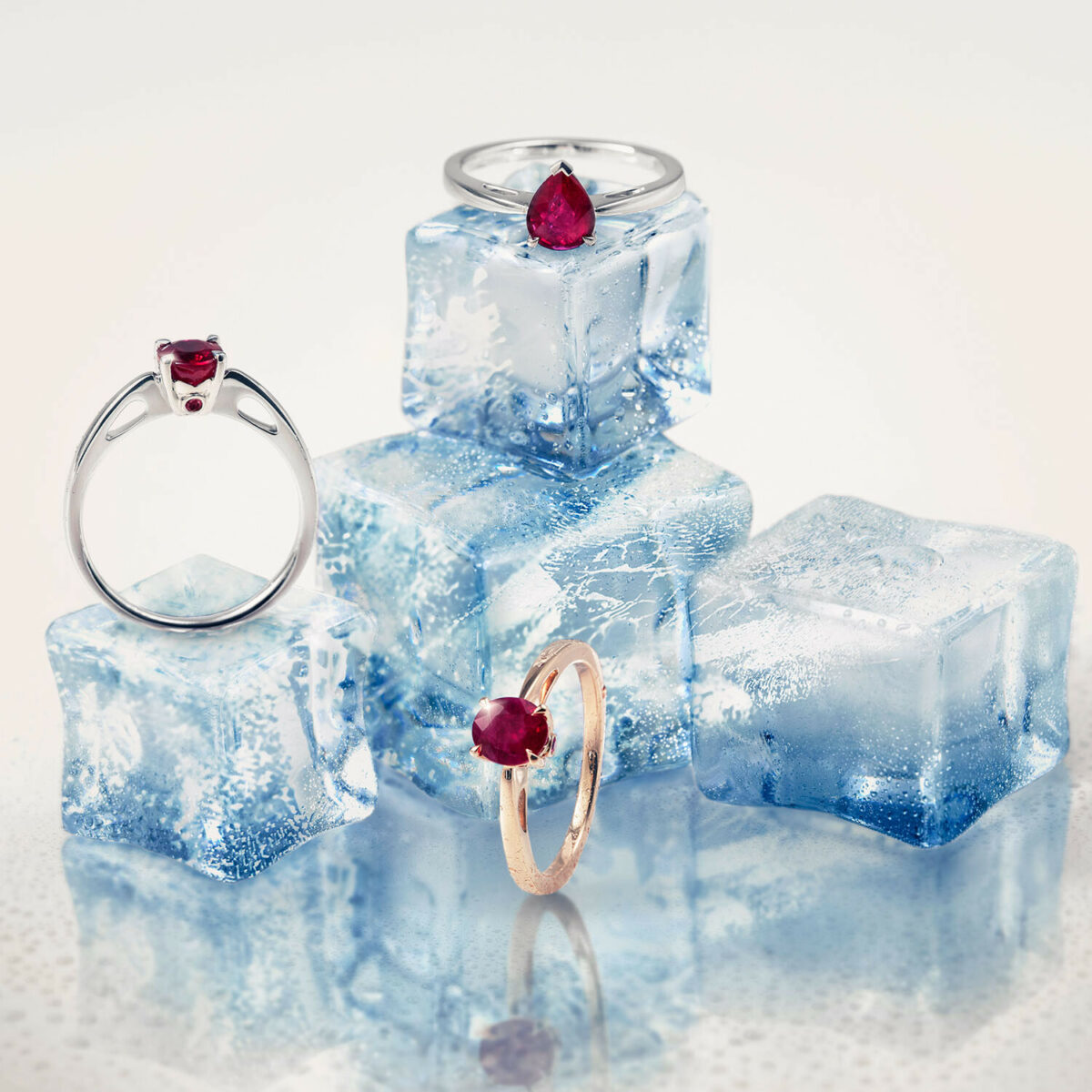 Three ruby rings displayed among ice cubes