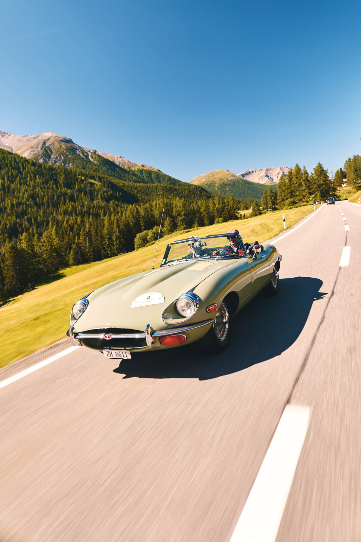 Classic car driven by a couple in the mountains