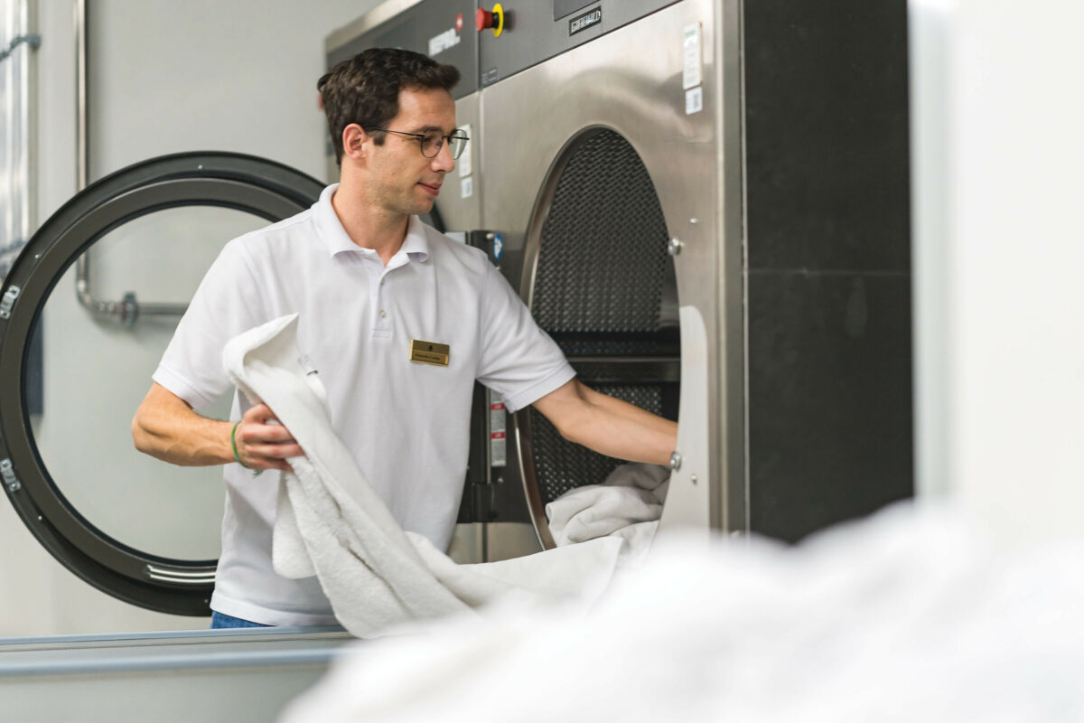 Hotel laundry staff member at work