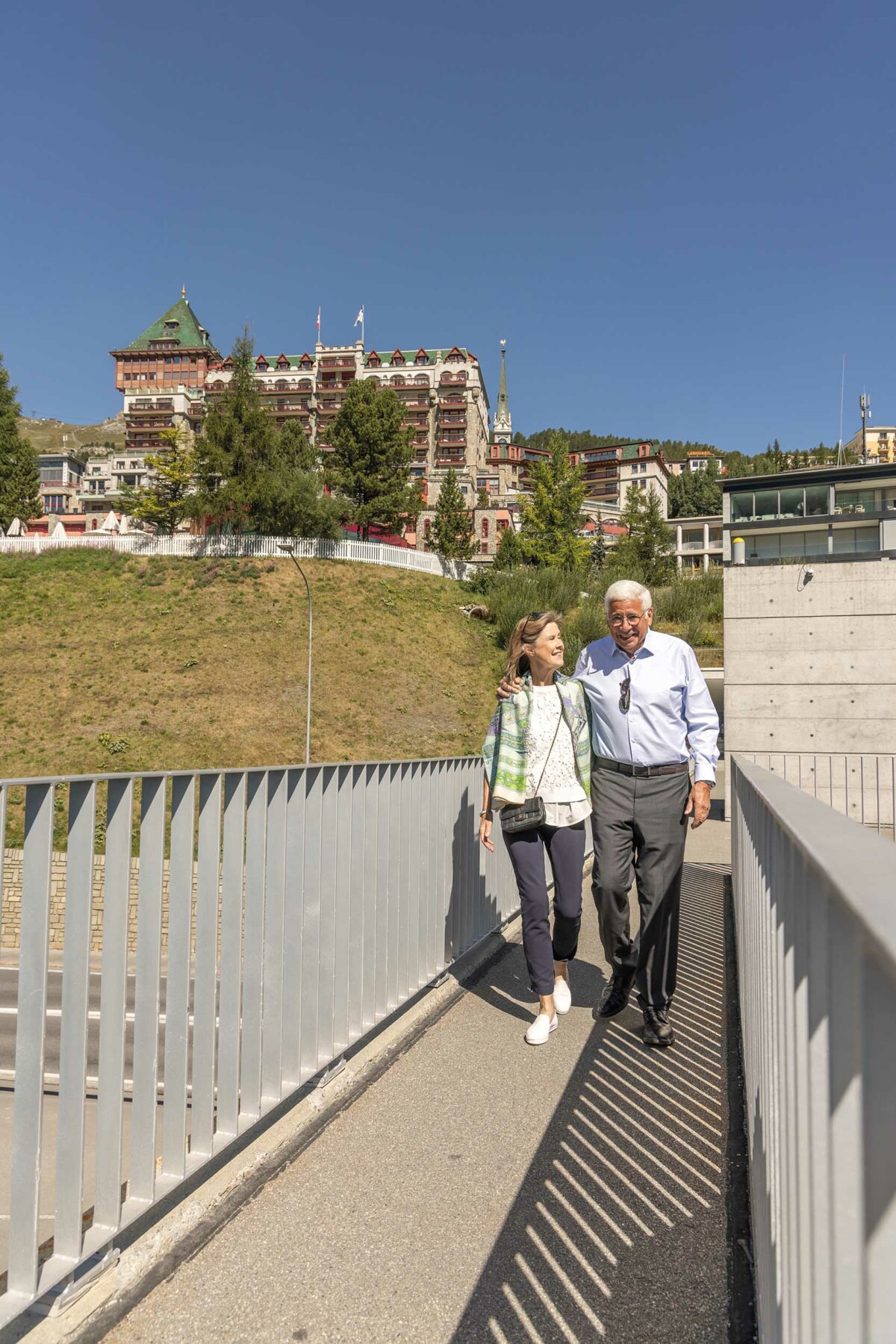 A couple on a walk by Badrutt's Palace