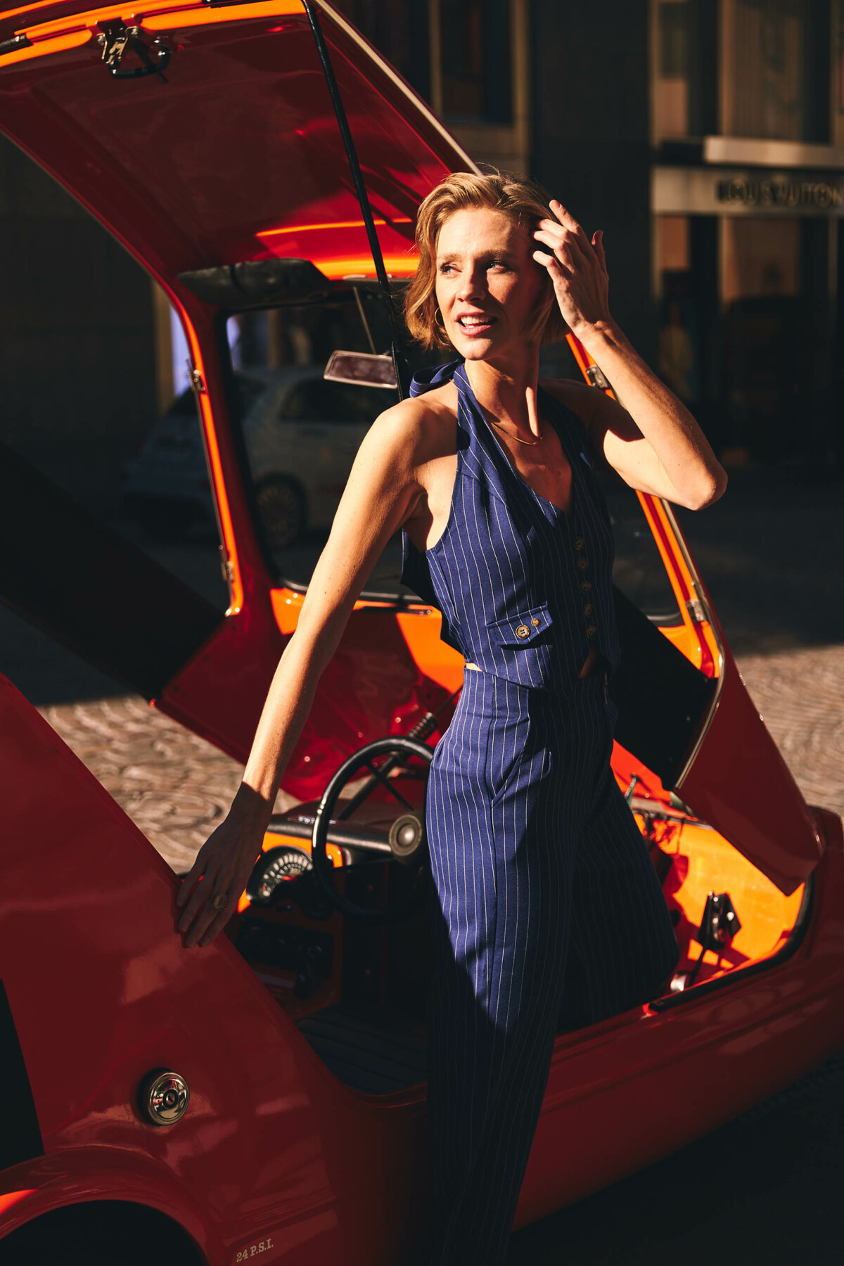 Elegant women getting out of a classic car