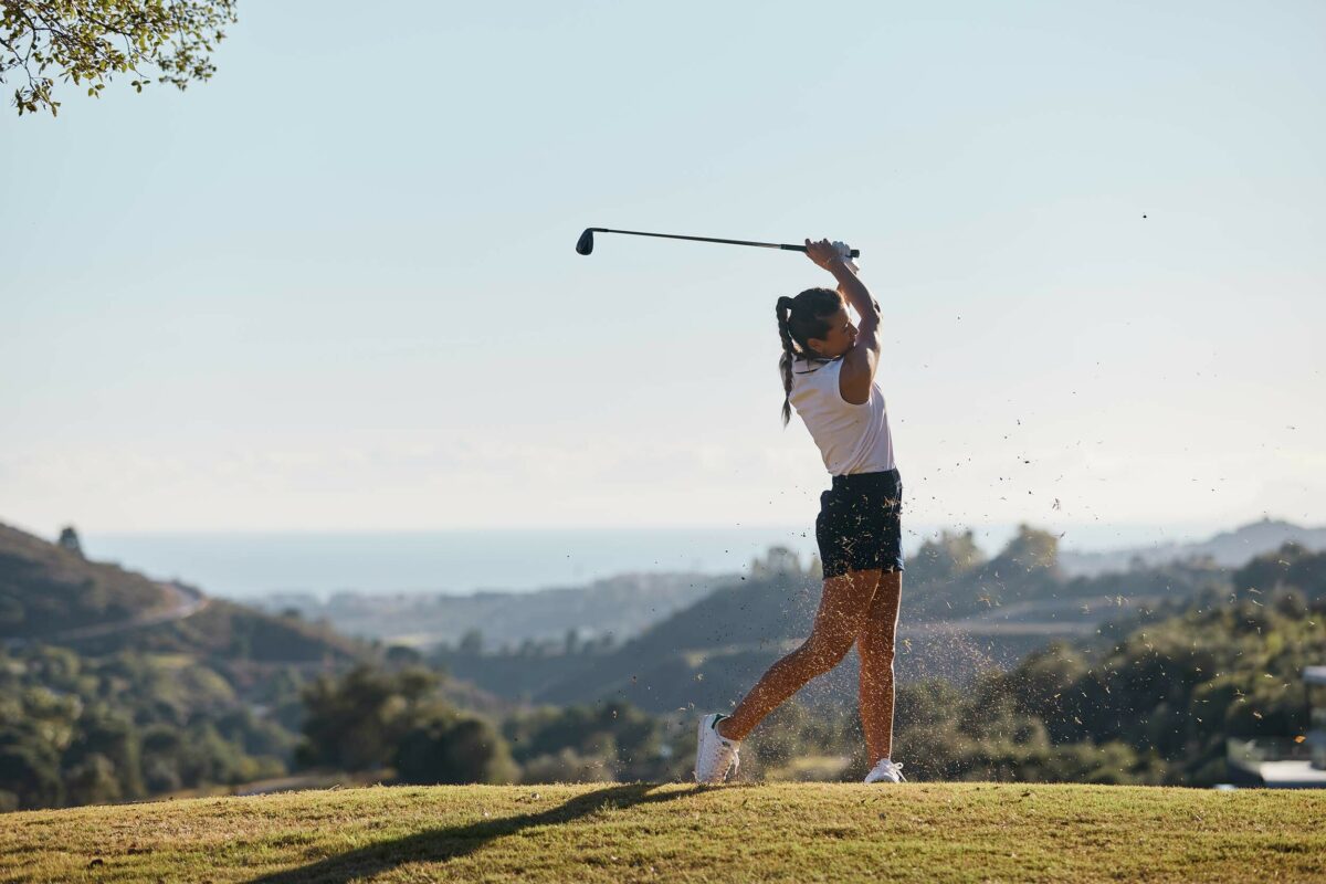 Young female golfer on a course