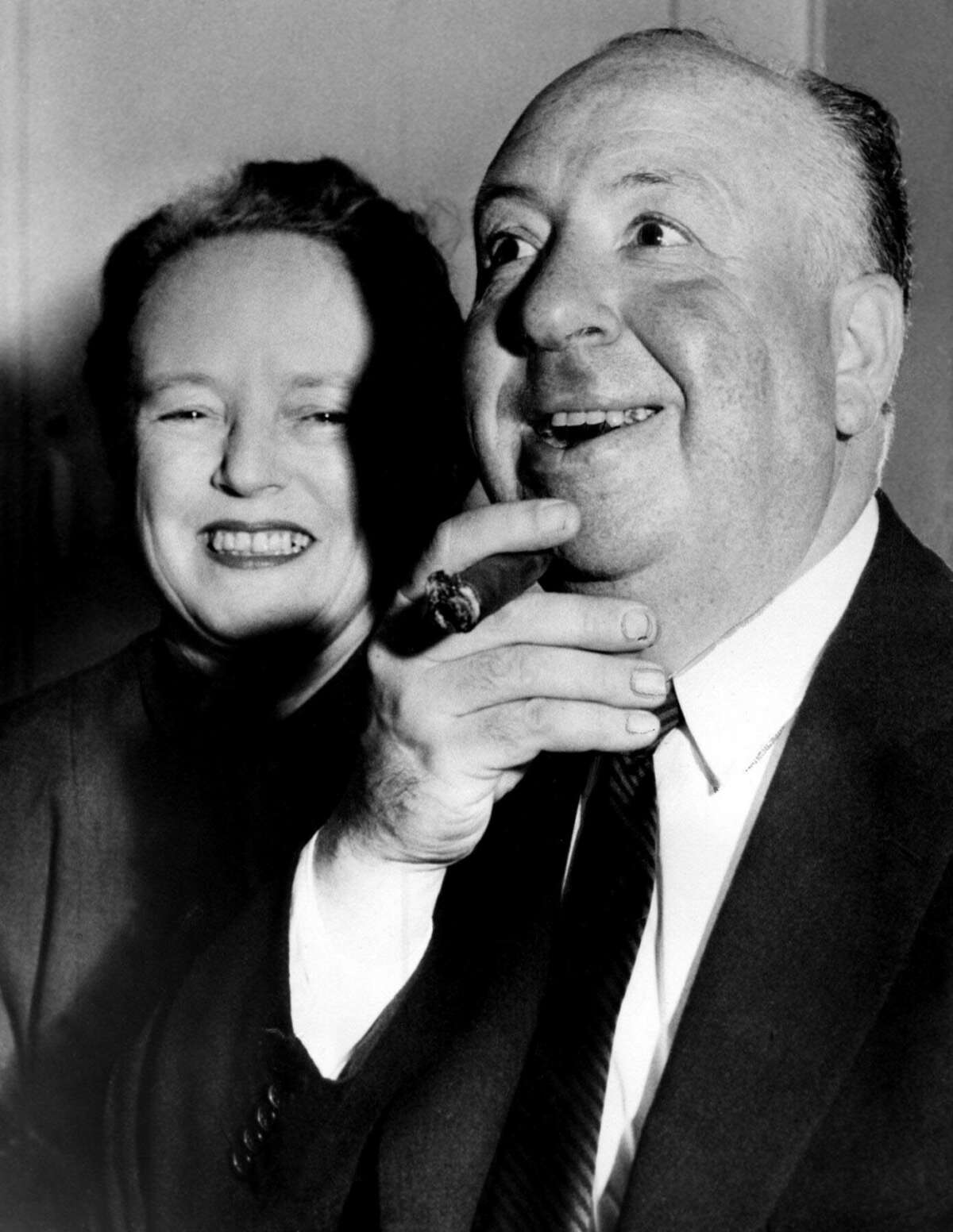 Black and white photo of man with cigar and his wife 