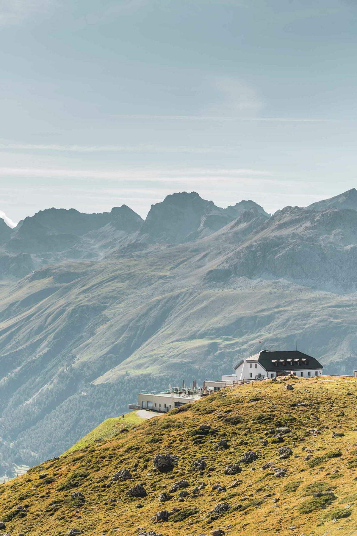 Building overlooking lake and mountains