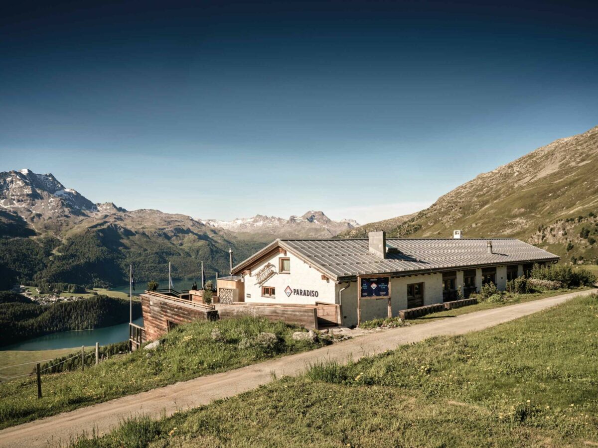 A building overlooking lake and mountains