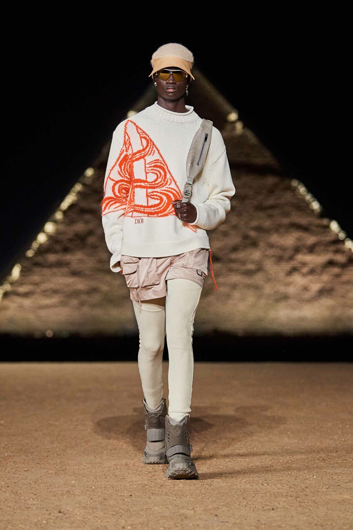 Male model on catwalk wearing white outfit