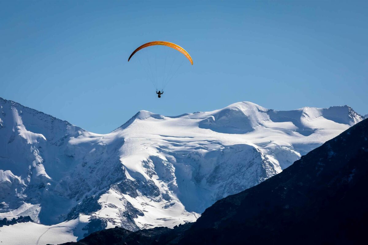 Paragliding over snowy mountains