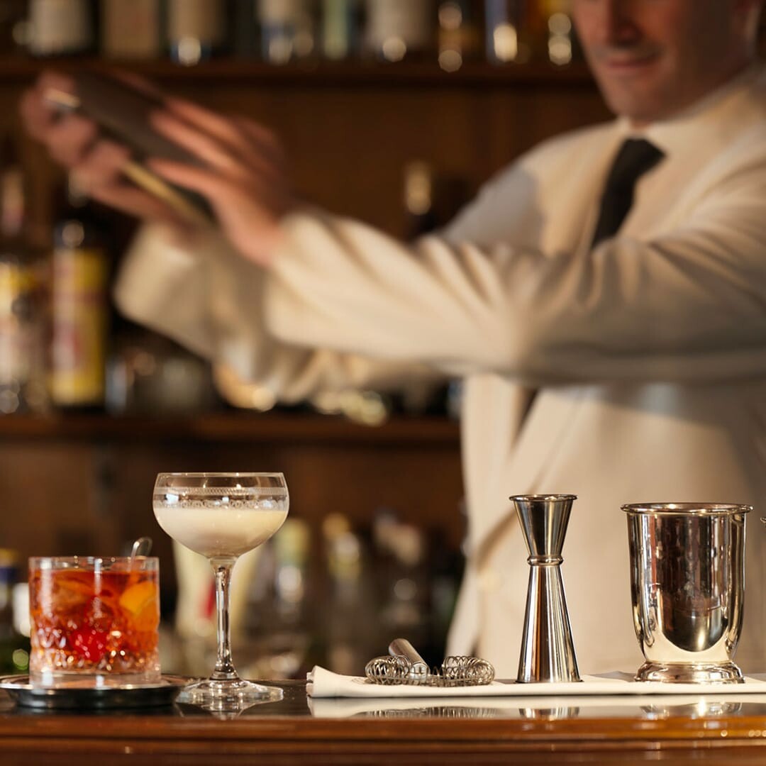 A bartender making a cocktail 