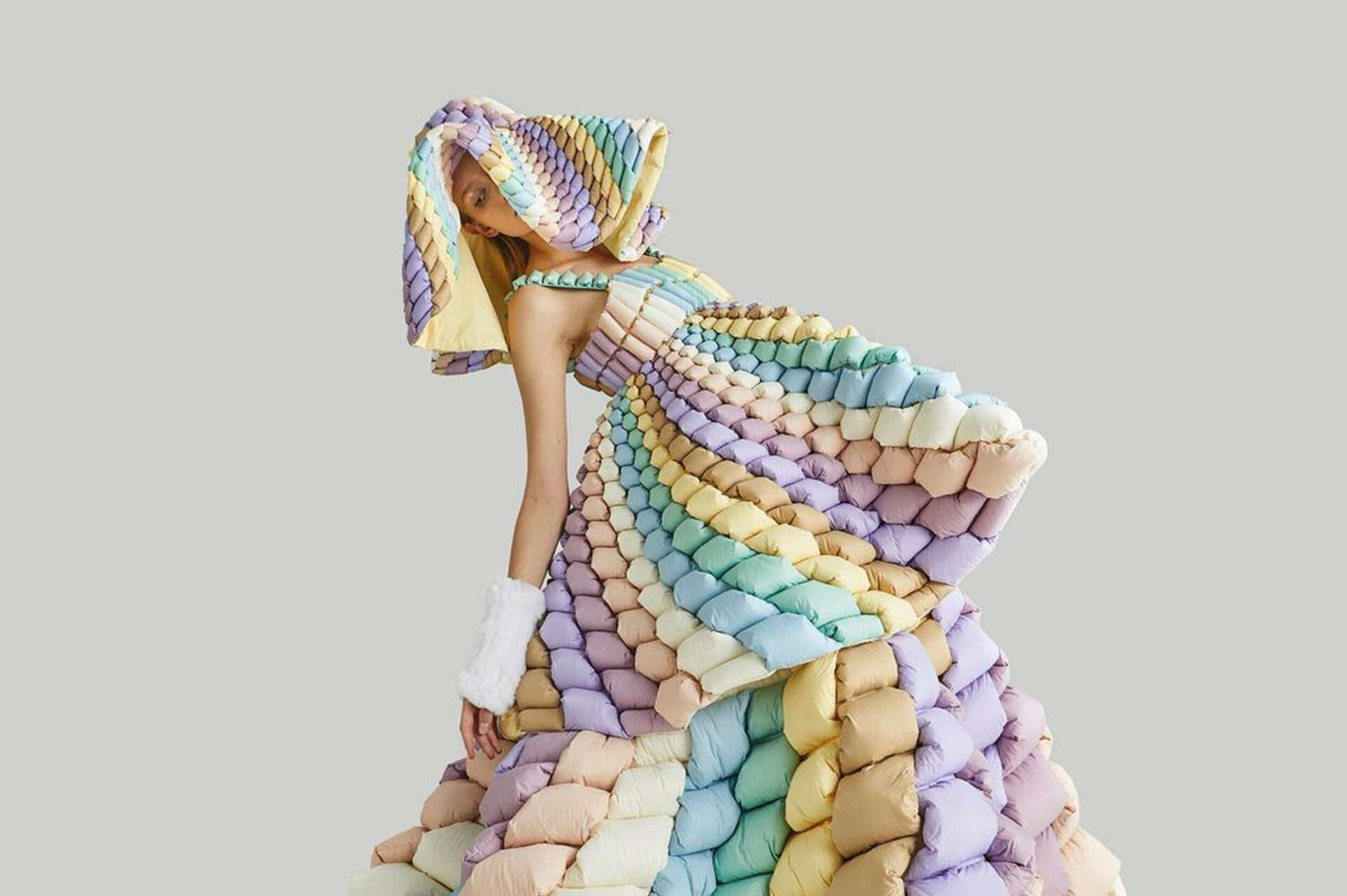 Female model wearing 3d-effect dress in pastel colours