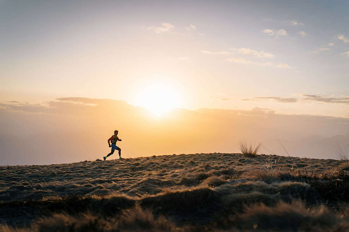 A runner in front of a sun set