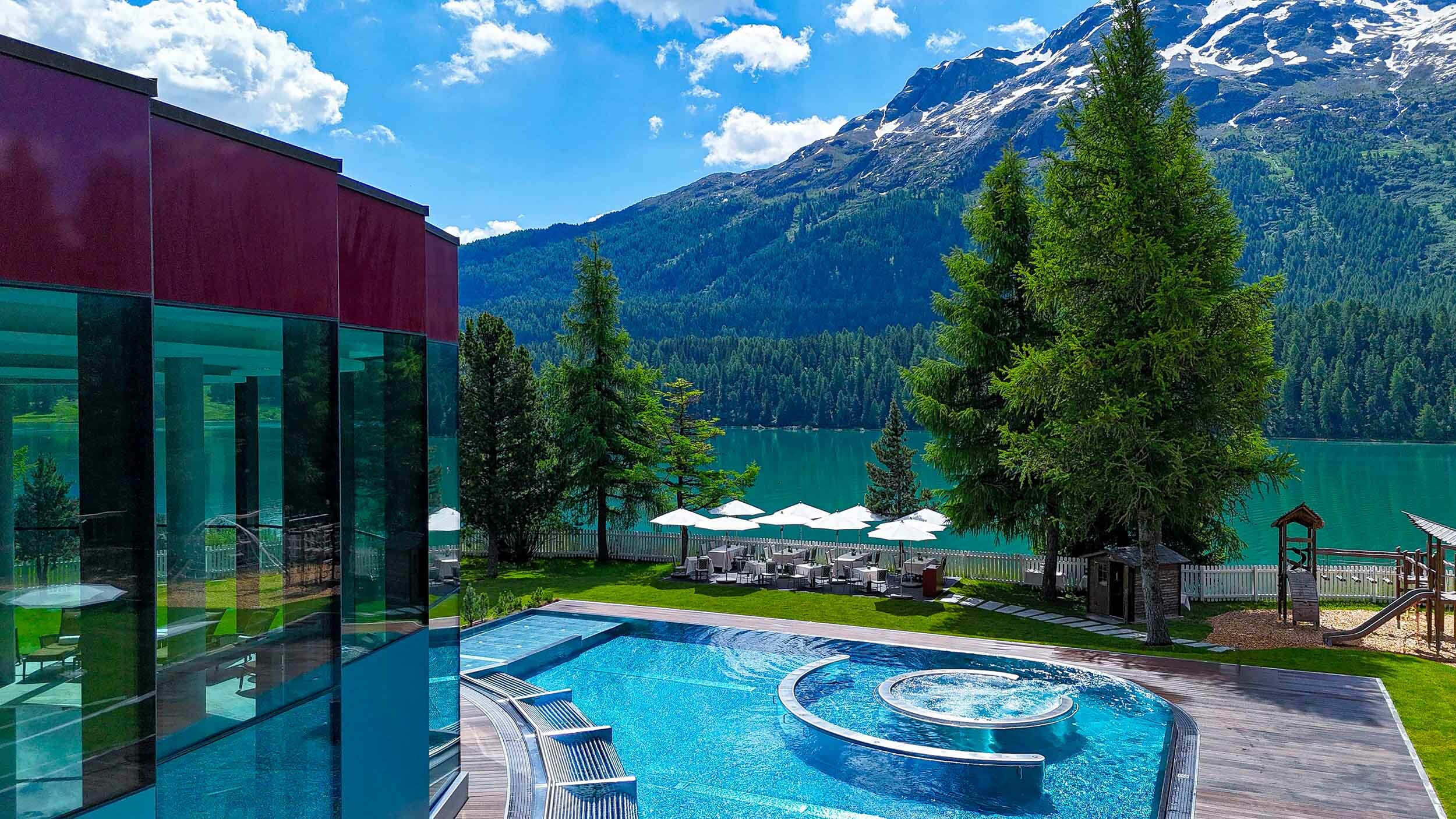 Swimming pool overlooking lake, forsests and mountains