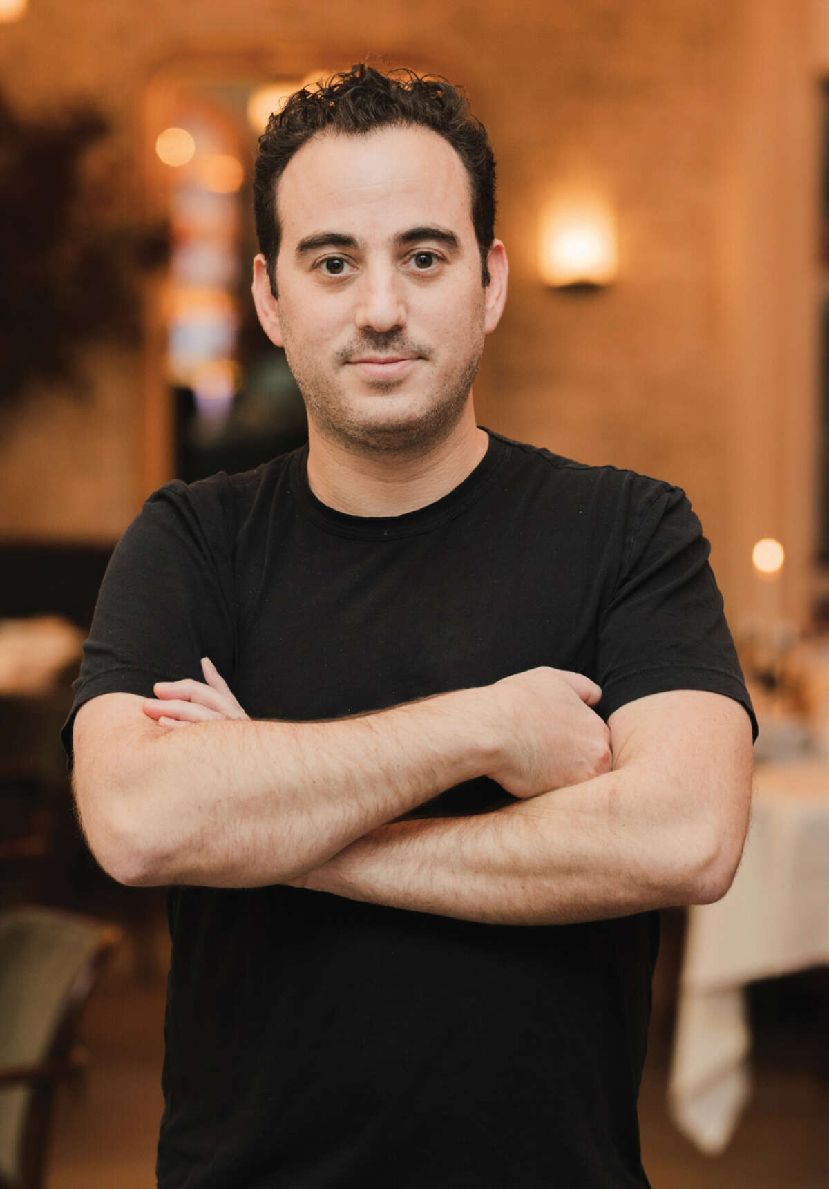 Portrait photo of a chef with arms folded