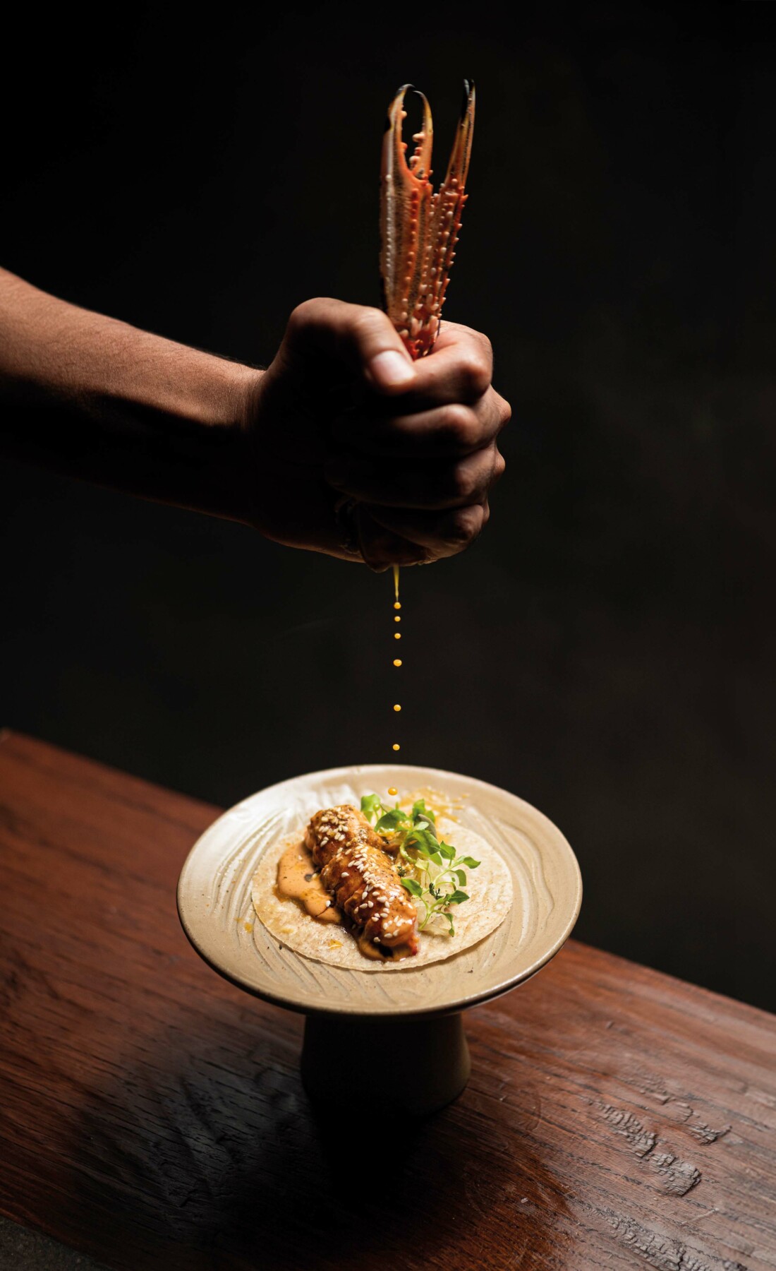 A chef adds finishing touches to a dish